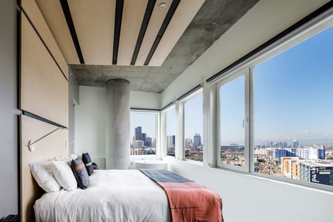 Wake up to sweeping city views beside a spa-like tub.