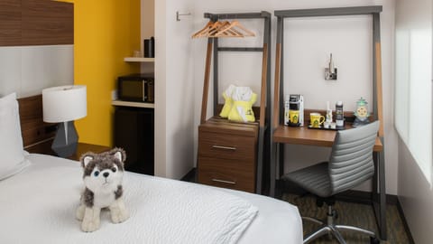 Work comfortably by the window with coffee setup and storage.