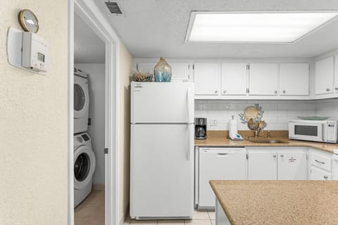 You have a convenient laundry space next to the fully equipped kitchen.