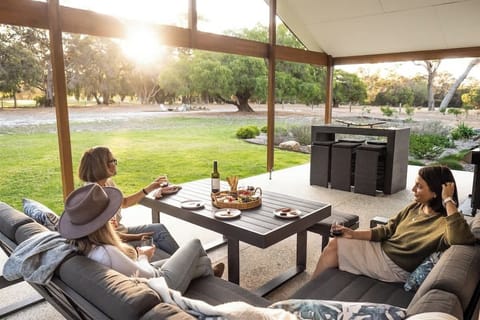 Relax beneath the verandah with sweeping views over the backyard and golf course.