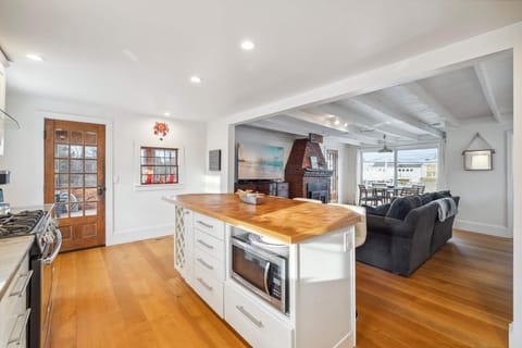 The fully equipped kitchen! This kitchen features a gas stove, seating for 4 at the island, a dishwasher and provided coffee! 