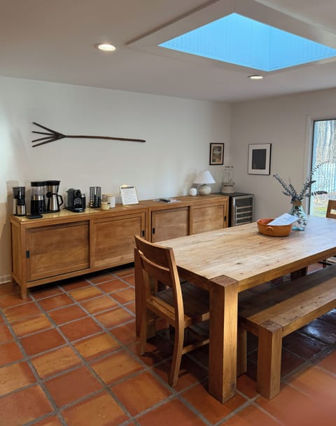 Big farm table seats 8 comfortably and coffee bar and wine fridge