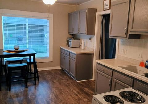 View of the kitchen with dining room table. 
