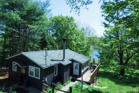 This Lakefront Kenoza Cottage is perched hillside with sweeping views of the lake.