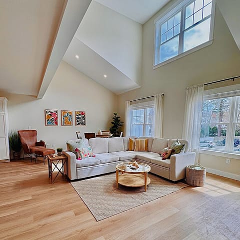 Spacious great room with oversized windows, light filtering blinds and curtains.