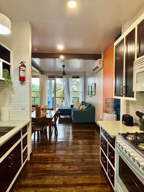 A charming one-bedroom suite with a fully stocked kitchen, stylish 4-seater dining table, and a cozy living room with plush seating—perfect for relaxing or entertaining after a day of exploring.