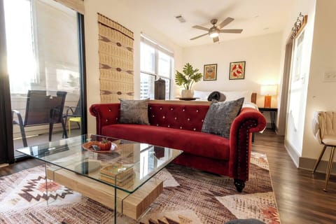 Balance and Harmony at the Stolisma Studio. Red Velvet chesterfield sofa, stylish mod coffee table, and local art from Gift Horse Studios in East Nashville.