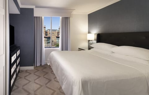 Wake up to sunlit comfort and a captivating city view.