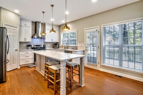 Kitchen with fully stocked cooking utensils/cookware with Eat In counter