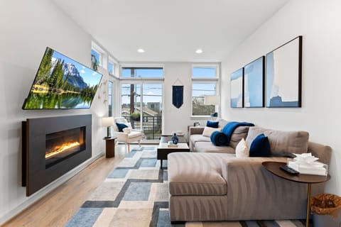The perfect spot to relax—fireplace glow, natural light, and a TV for entertainment.
