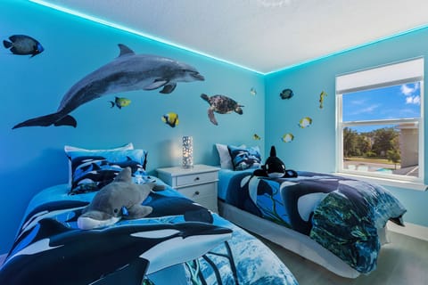 SeaWorld Orlando bedroom with two twin beds, LED light up mirror and ceiling fan and LED lights!