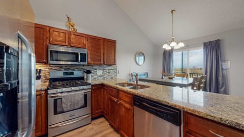 A warm and inviting kitchen with stainless steel appliances, rich wood cabinetry, and a stunning granite countertop—perfect for cooking and gathering! 🍽️✨🏡