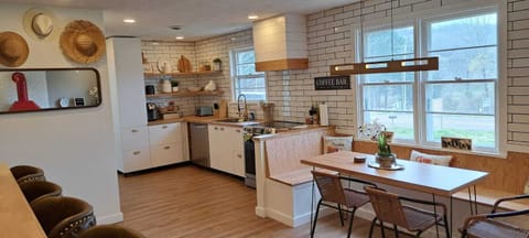 Stylish kitchen and dining space with large windows and views of wine country
