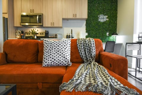 Bold living area with kitchen access and stylish seating. 🛋️