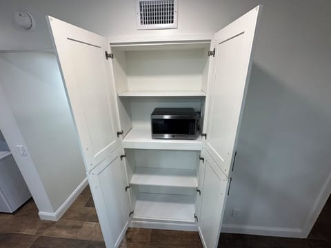 Kitchen pantry with microwave.