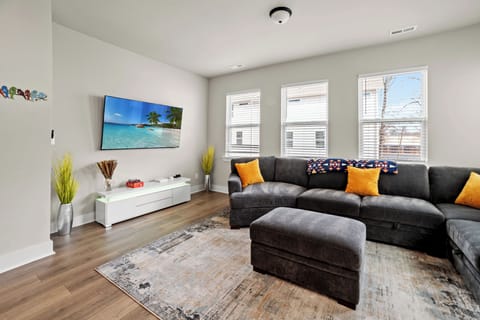 Comfortable living space with a spacious 7-seater couch, 65-inch TV with Netflix