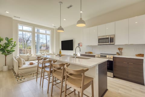 Kitchen features an island with barstool seating.(Lischey)