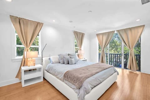 Relax in this serene, modern bedroom 1 designed for comfort. Enjoy a plush bed, elegant décor, and sunlit windows. Step onto the private balcony for peaceful views—your perfect retreat awaits!