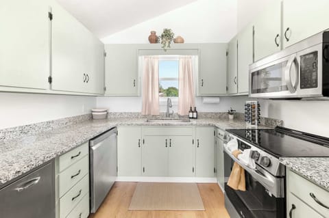 Fully stocked kitchen (#1) with all your cooking needs - dinnerware, glassware, cooking pots/pans, seasonings, and cleaning supplies. This is the kitchen located upstairs.