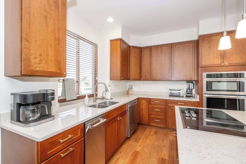 The chic, open kitchen offers ample space & every home comfort