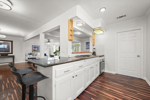 The kitchen features ample cabinet space for all your essentials, along with modern appliances and sleek countertops.