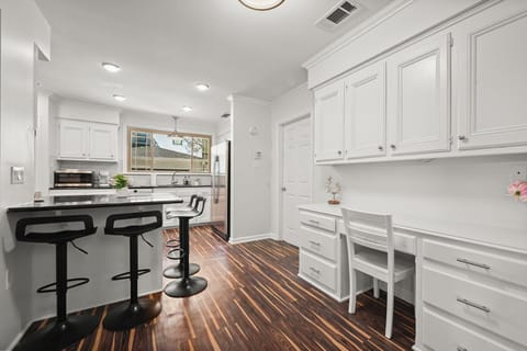 The kitchen is fully equipped with modern appliances and ample cabinet space for your convenience.