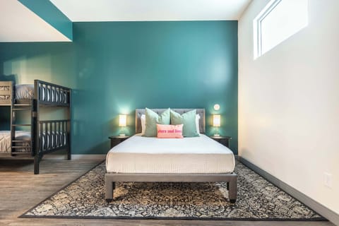 Drift into restful sleep on a cozy queen bed and a bunk bed, complete with plush pillows and high-quality linens for ultimate comfort.