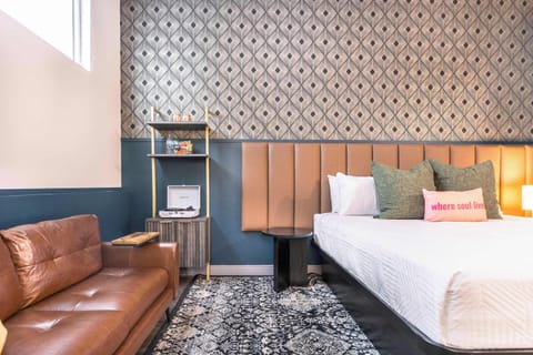 Unwind in this inviting studio with a cozy king bed, premium linens, a comfy couch, and soft, warm lighting for a relaxing atmosphere