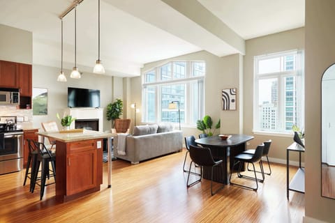 Huge open living space with tall ceilings and oversized windows overlooking the city