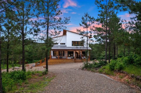 Luxury forest cabin in Hochatown surrounded by towering pines; peaceful private setting just minutes from Broken Bow Lake and Beavers Bend State Park.