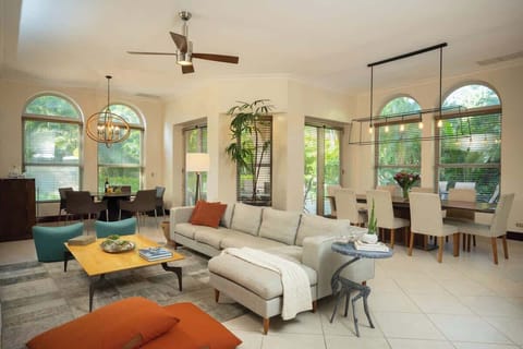Open concept Living area with dining table, bar to the left and kitchen to the right