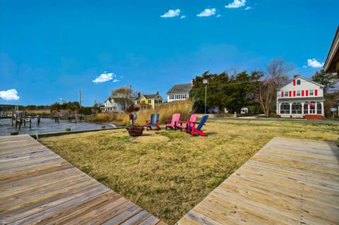 Expansive riverside yard with direct access to the water and Adirondack seating.