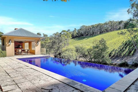 For those seeking a tranquil retreat, the infinity-edge pool offers breathtaking views of the neighboring vineyard from its elevated stone terrace, blending the waterline seamlessly with the natural landscape.