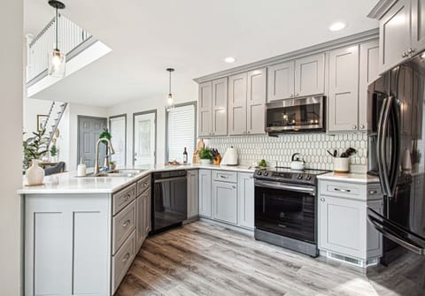 Modern elegance in the kitchen: new black stainless steel appliances, and the ease of soft-close cupboards and drawers in our fully equipped space.