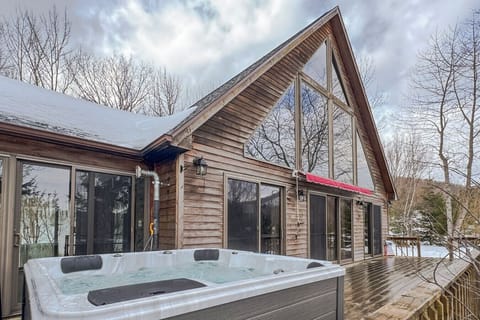 Enjoy the best of indoor and outdoor living with this stunning A-frame cabin and a relaxing hot tub on the deck.