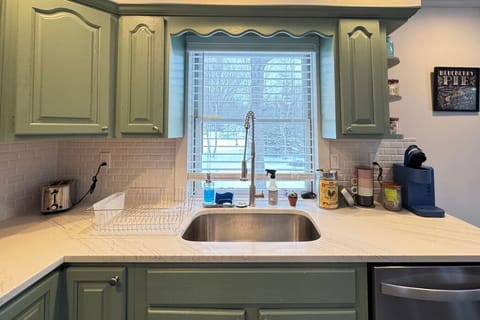 Bright kitchen corner with a scenic window view, perfect for enjoying your morning coffee.