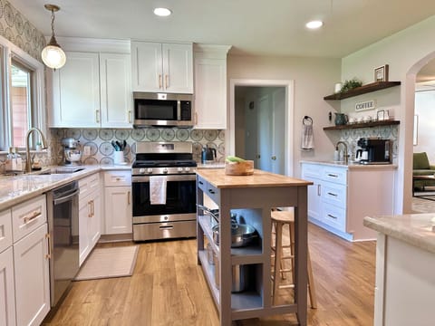 Kitchen with eat-in island and coffee bar.