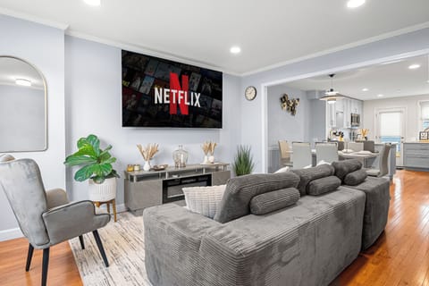 Spacious main living room with plush seating,  Samsung 8K 85” smart TV.