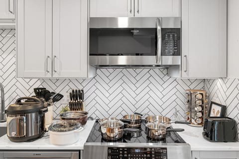 Fully equipped cooking station with a electric cooking top, oven, and air fryer.