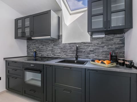 Furniture, Wood, Interior Design, Flooring, Kitchen, Cabinetry, Floor, Room, Major Appliance, Cupboard