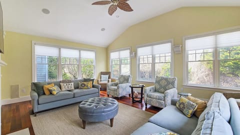 Living room with comfortable seating, large flat screen TV and fireplace