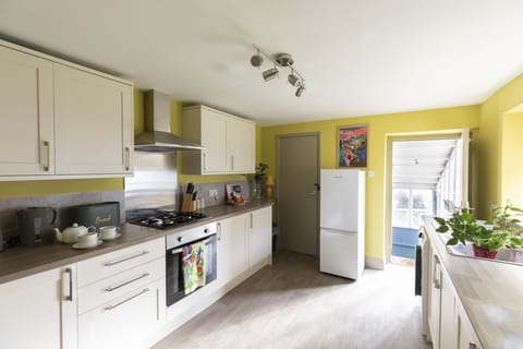 Palace Garden Cottage - the contemporary kitchen with a door leading out to the garden
