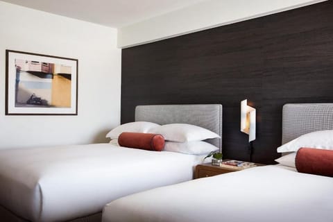Recharge in a minimalist room accented by warm, modern lighting.