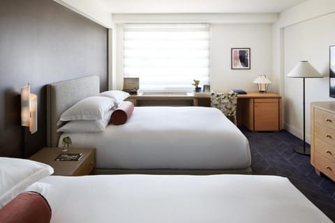 Stretch out on plush beds and savor the serene modern design.