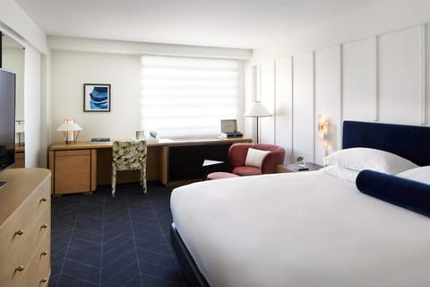 Settle into a bright, airy bedroom with plush bedding.