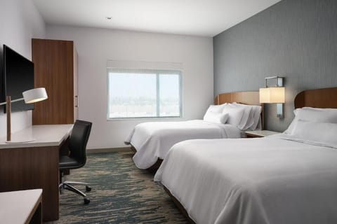 Recharge in quiet comfort with a workspace and soft bedding.