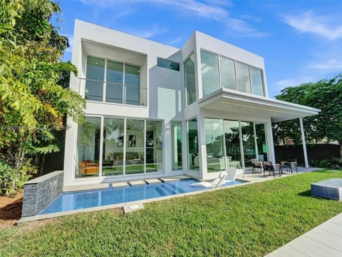 Refined luxury residence showcasing contemporary design excellence with crystal clear pool and lush tropical garden surroundings