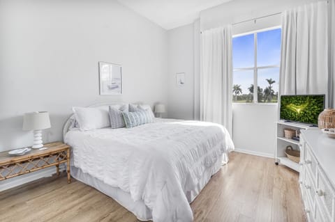 Relax in the serene comfort of the main bedroom, featuring plush bedding, peaceful views, and a private en-suite bathroom for added convenience and privacy.