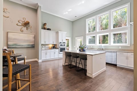 Culinary enthusiasts will find everything they need in the fully equipped kitchen featuring modern appliances, granite countertops, and a large kitchen island.