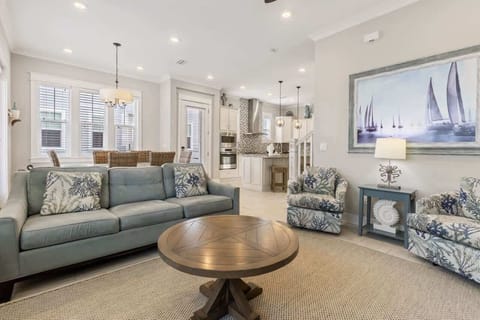 Living room: Main floor, 75" Smart TV, couches and chairs, patio and garage access, central heating and A/C
